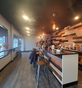 Inside Night Owl — warm wood counter and pendant lighting